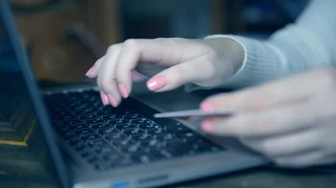 Woman using computer for on line purchase with credit card. Toned in blue color Stock Footage 56611507