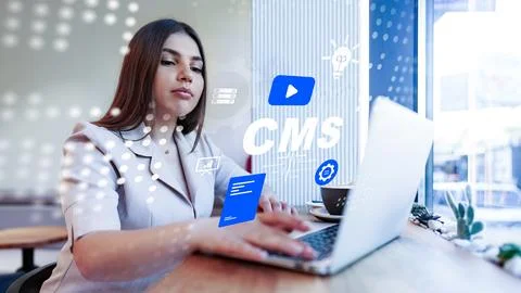 Woman using computer to manage content in a system at a modern workspace 写真素材