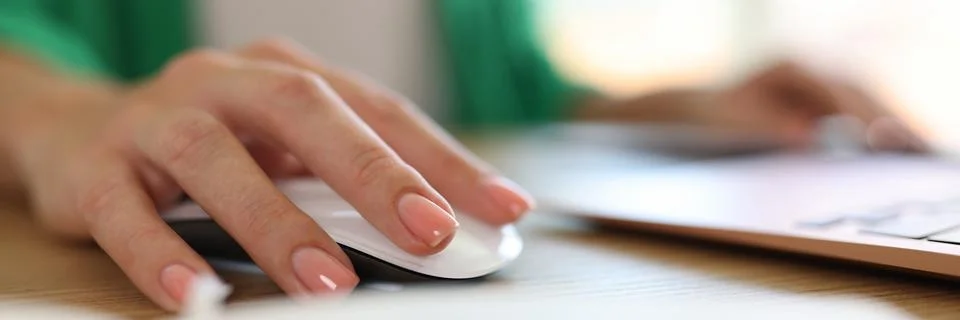Woman using computer mouse working on modern laptop in office Stock Photos
