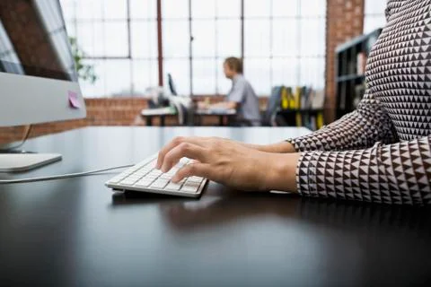 A woman using a computer in an office 스톡 사진