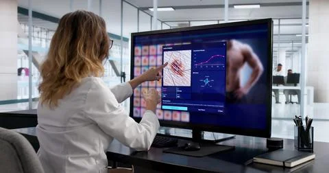 Woman Using Computer To Screen For Skin Cancer Detection Options. Stock Photos