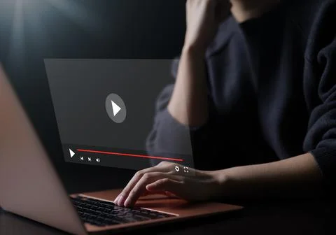 Woman using a computer for streaming online on virtual screen, watching. Stock Photos