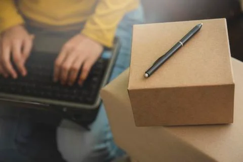 Woman using a computer while sitting at the modern working desk  by stack of  Stock Photos