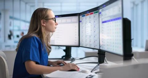 Woman Using Credentialing Software On Desktop To Manage Healthcare Data Effic Stock Photos
