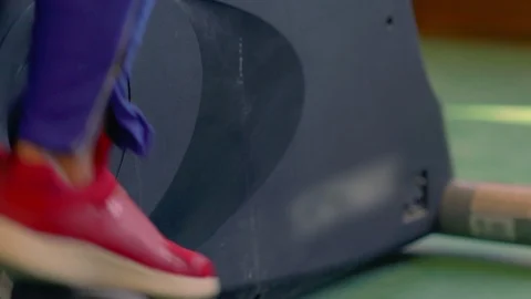 Woman using a cycling machine in a gym Stock Footage 121450153