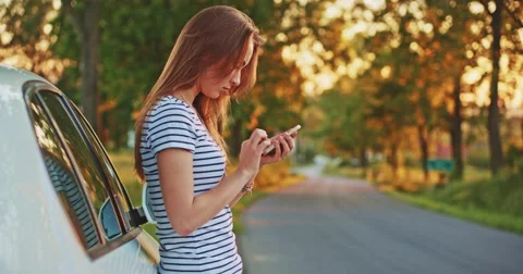 Woman using digital smartphone in the car. Filmed in 4K DCi resolution.  库存影片 50956947