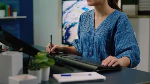 Woman using digital stylus on tablet at desk Stock Photos