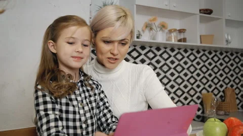 Woman using digital tablet and spending time with daughter Stock-Footage 110792712