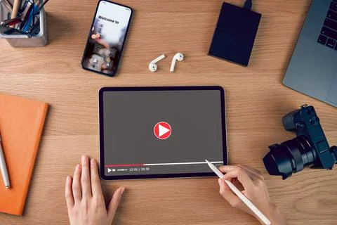 Woman using digital tablet and watching video online with camera and access.. Stock Photos