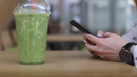 Woman using digital tablet browsing internet cafe interior smartphone messaging Stock Footage 75608702