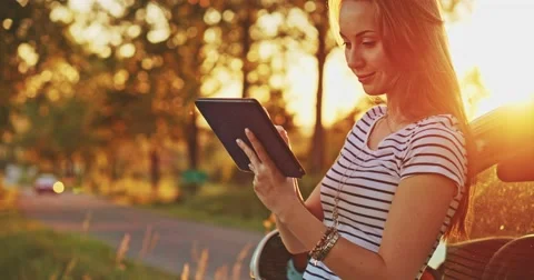 Woman using digital tablet by the car. Filmed in 4K DCi resolution. Young woman Vidéo 50955877