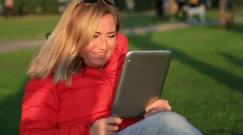 Woman using digital tablet in the city park 2 Stock Footage 62652391