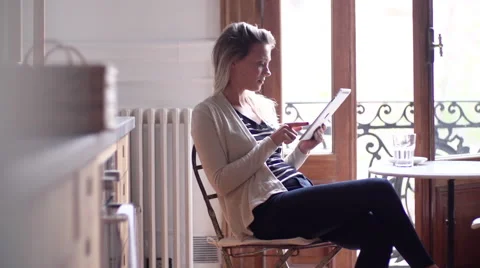 Woman using digital tablet at home Stock Footage 63296299