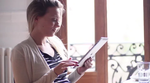 Woman using digital tablet at home Stock Footage 63296346