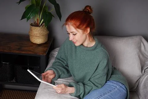 Woman using digital tablet or ebook reader at home Stock Photos