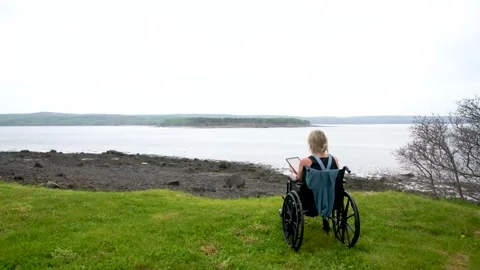 A woman using a digital tablet outside at a scenic lookout Stock Footage 155170530