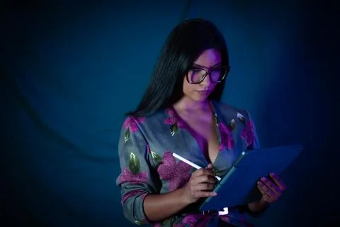 Woman using digital tablet with stylus in dim light Stock Photos