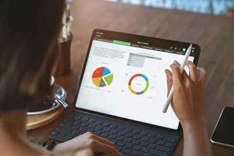 A woman using digital tablet third person view Stock Photos