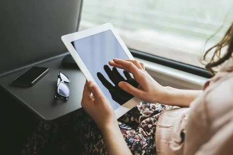 Woman using a digital tablet on the train Stock Photos
