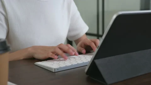 Woman using digital tablet with working, type keyboard on office desk. 스톡 동영상 135503380