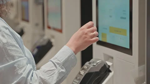 Woman using display for ordering and paying on food-court of fast-food Stock Footage 265112072