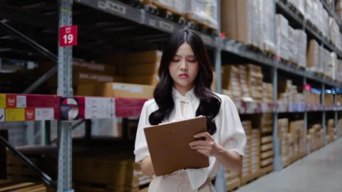 Woman using document file updates inventory records, thinking about project Stock Footage 315731570