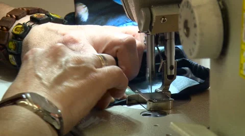Woman Using Electrical Sewing Machine. Sawing Clothing Process. Brightly Lit Stock Footage 68029980