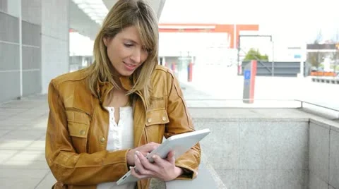 Woman using electronic tablet in front of modern building Stock Footage 14833401