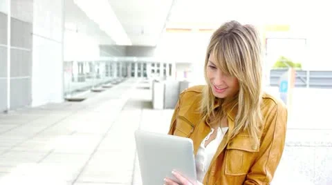 Woman using electronic tablet in front of modern building Stock Footage 14833404