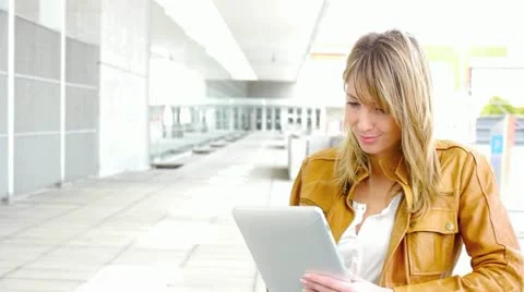 Woman using electronic tablet in front of modern building Stock Footage 14833406