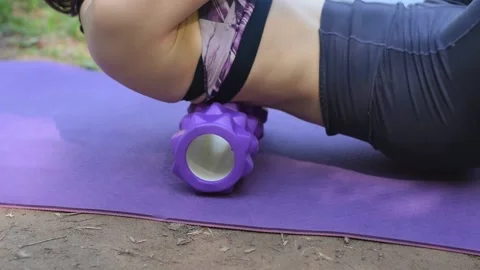 Woman using a foam roller to roll out back muscles.Myofascial release Stock Footage 154858584