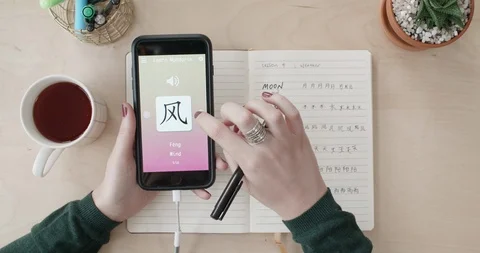 Woman using foreign language learn chinese mobile phone app at home Stock Footage 90311529