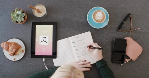 Woman using foreign language learn mandarin chinese mobile phone app Stock Footage 90313907