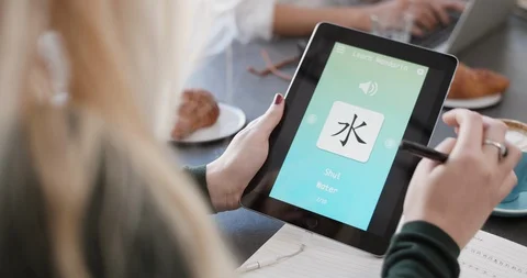 Woman using foreign language learn chinese mobile phone app Stock Footage 90314957