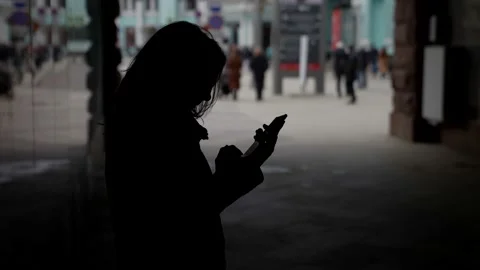 A woman using the function of writing a smartphone message online, in an urban Stock Footage 153483598