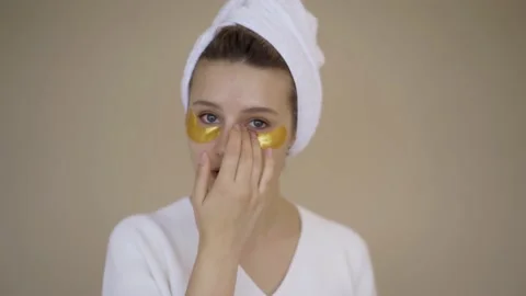 Woman Using Gel Eye Patch Mask. Beautiful woman using facial mask beauty product Stock Footage 142201061