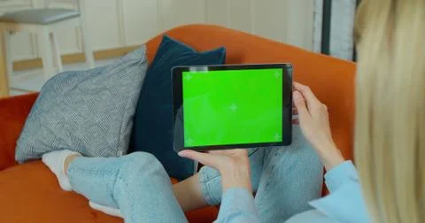 Woman Using Gestures with Touchscreen Device, Browsing Internet, Watching Stock Photos