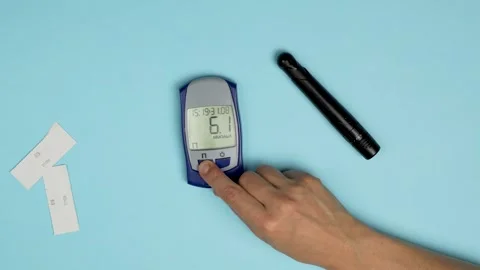 Woman using glucometer, checking blood sugar level Stock Footage 254010587