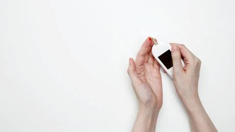 Woman using glucometer for testing level Blood sugar. Top view Stock Photos
