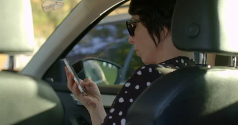 Woman using GPS app for navigation in car woman is using a GPS app on smartphone Stock Footage 275854403