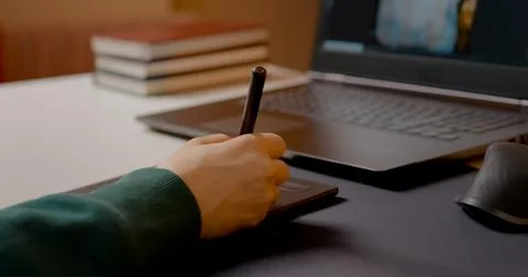 Woman using graphics tablet for retouching in home studio workspace Stock Photos