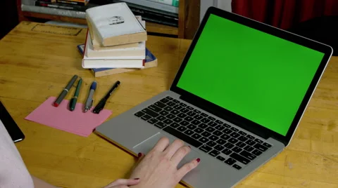 Woman using a green screen macbook pro Stock Footage