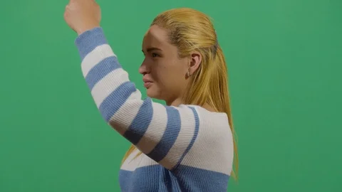 Woman using the hand as a shade studio isolated shot against green screen Stock Footage 117716697