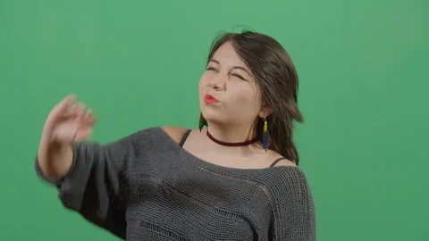 Woman using the hand as a shade studio isolated shot against green screen Stock Footage 117978484