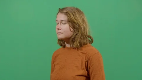 Woman using the hand as a shade studio isolated shot against green screen Stock Footage 117980587