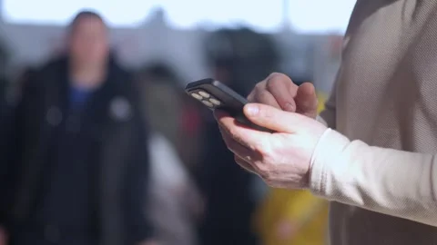 Woman is using her cell phone while sitting at a table with a cup of coffee Stock Footage 304959255