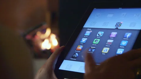 Woman using her iPad - fireplace in the background Stock Footage 47140102