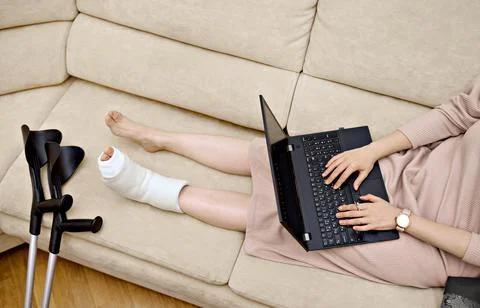 A woman is using her laptop to communicate with a doctor in an online sessi.. Stock Photos