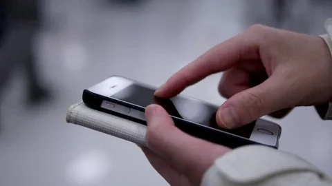 Woman using her mobile phone on beautiful blurred lighting background Stock Footage 69215352