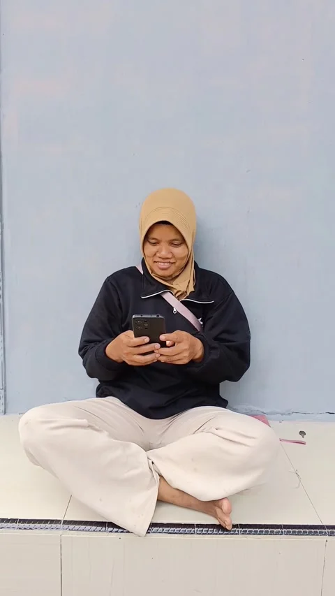Woman using her smartphone and celebrating success. Video stock 335019257